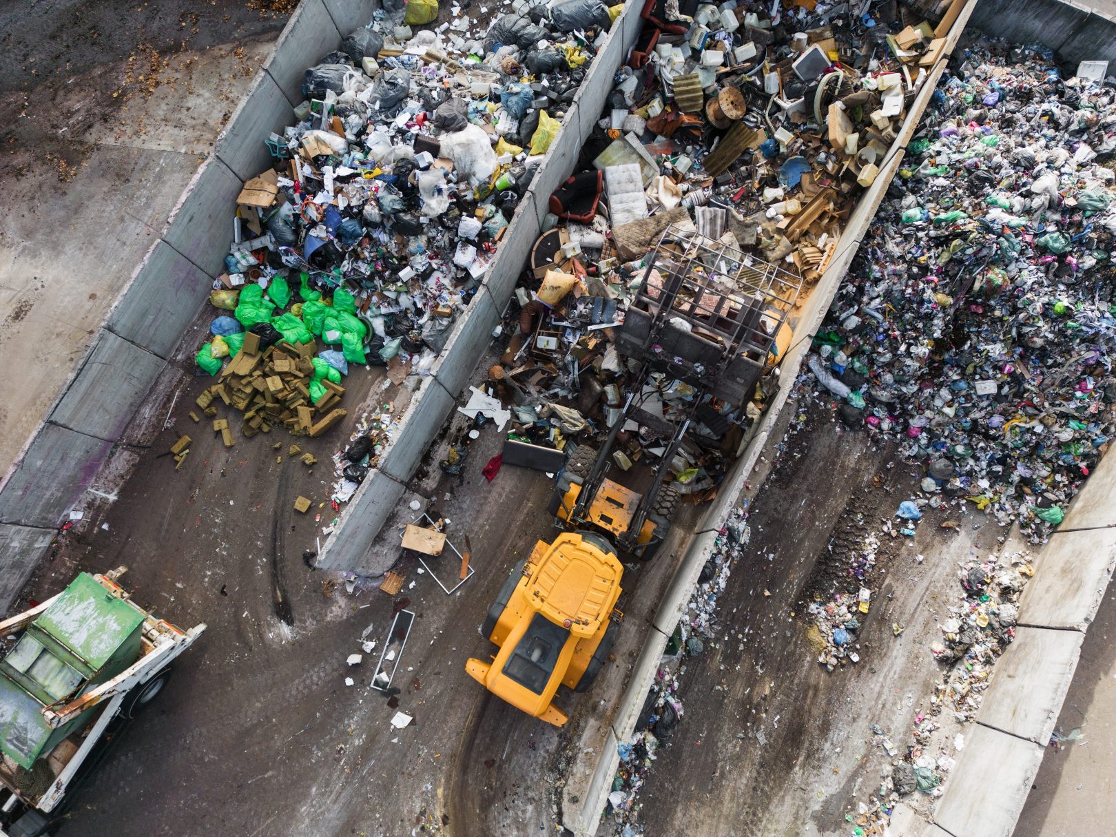 Wheeled loader moving garbage at a landfill